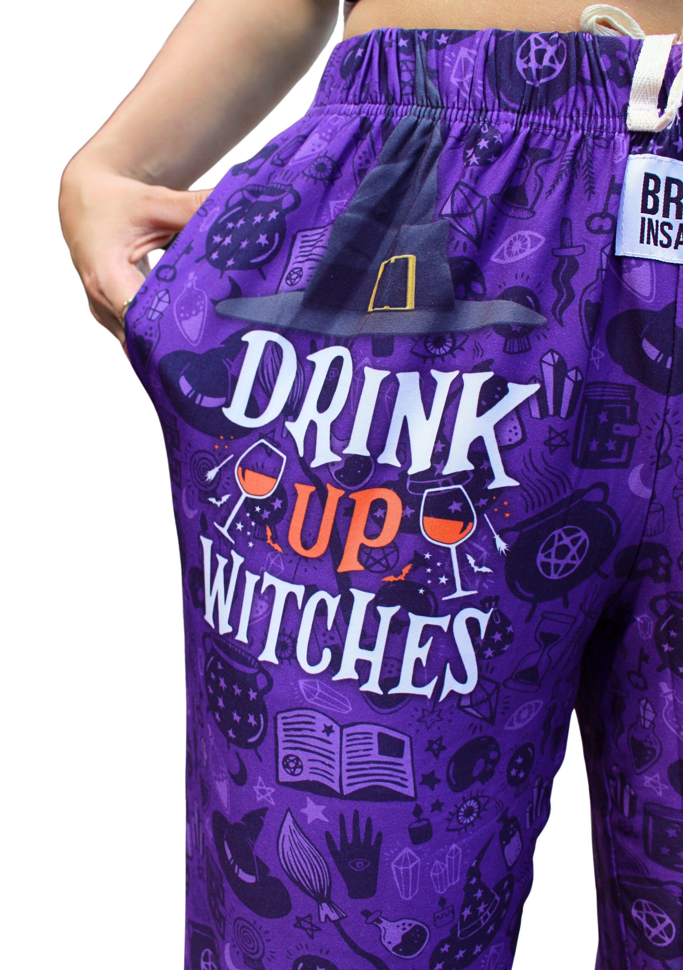 Drink Up Witches Pajama Lounge Pants close up view of "Drink Up Witches" text
