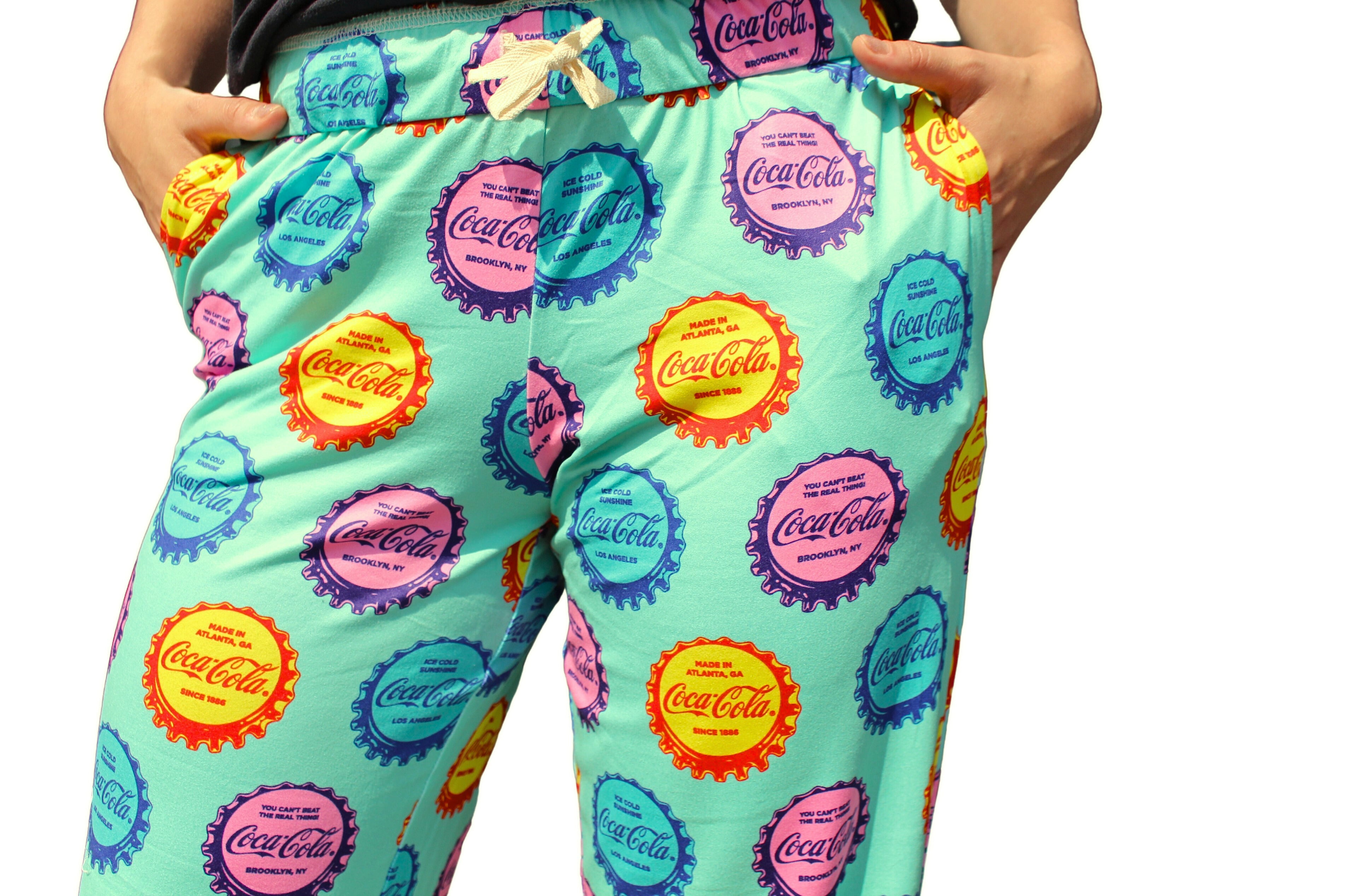Coca-Cola Cap Pattern Pajama Lounge Pants on model close up front view (waist down to midway of pants)