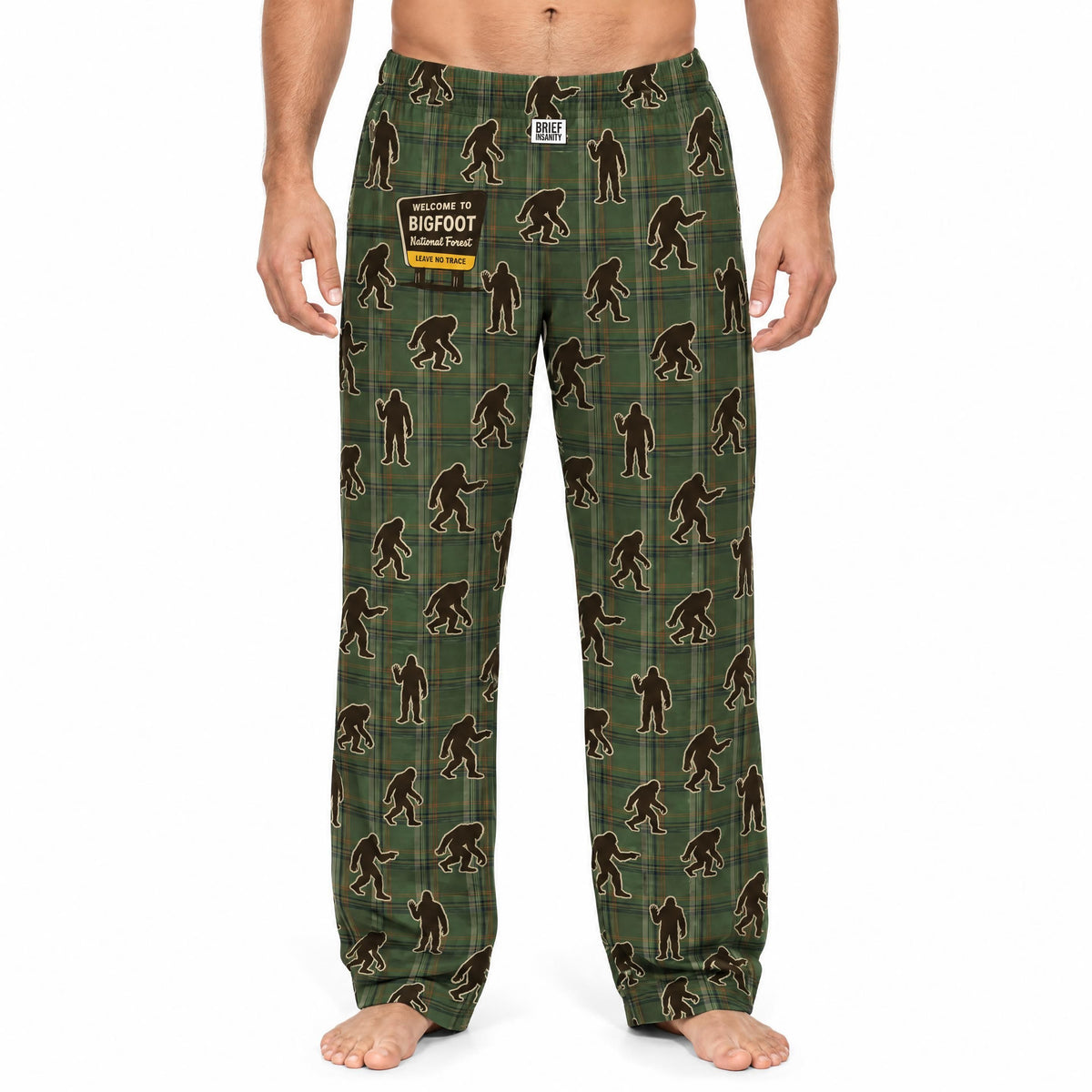 Male model wearing Bigfoot plaid lounge pants with Bigfoot National Forest patch on a white background.