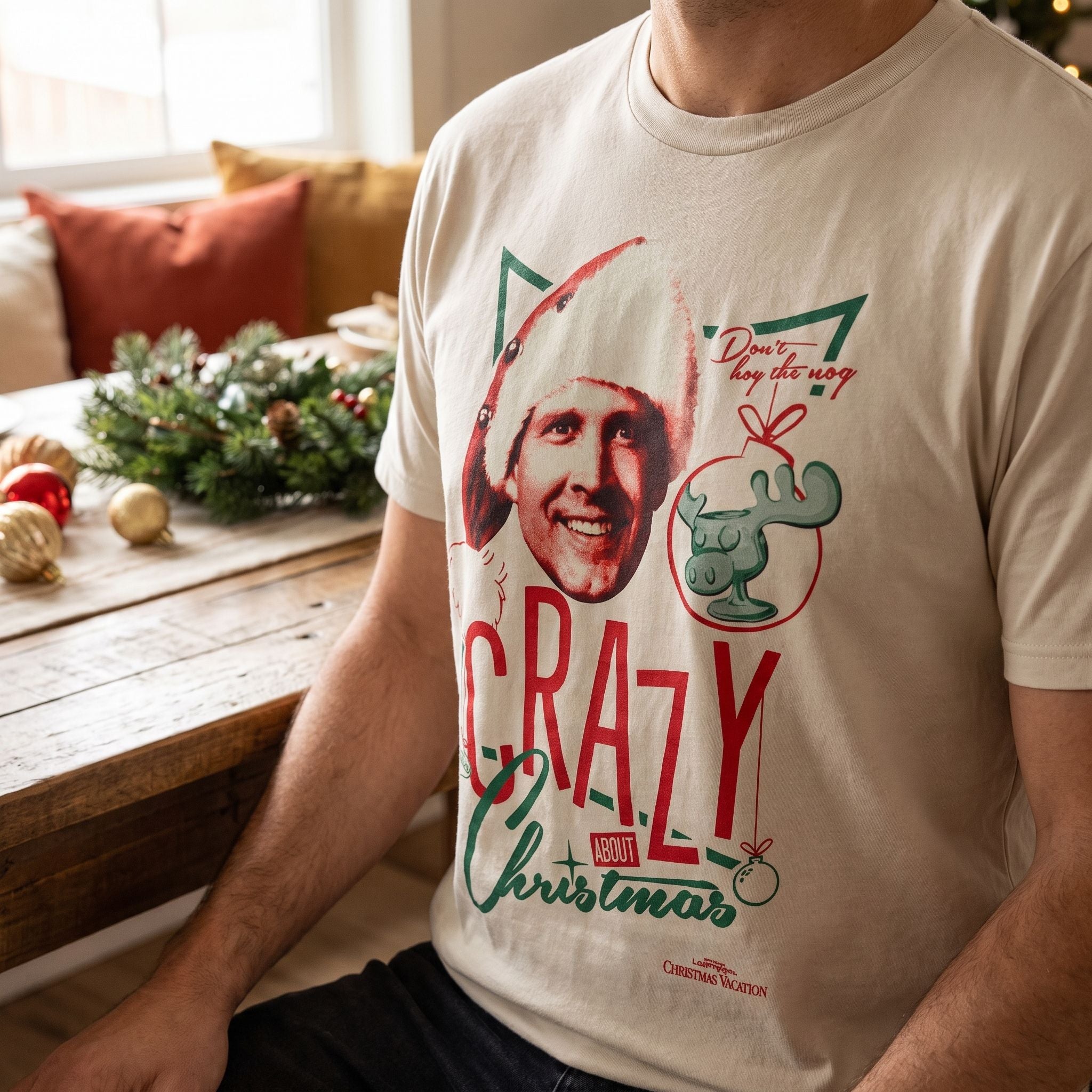 Close-up of the Christmas Vacation shirt's fabric on a model at a decorated table, highlighting softness and stretch with holiday decor