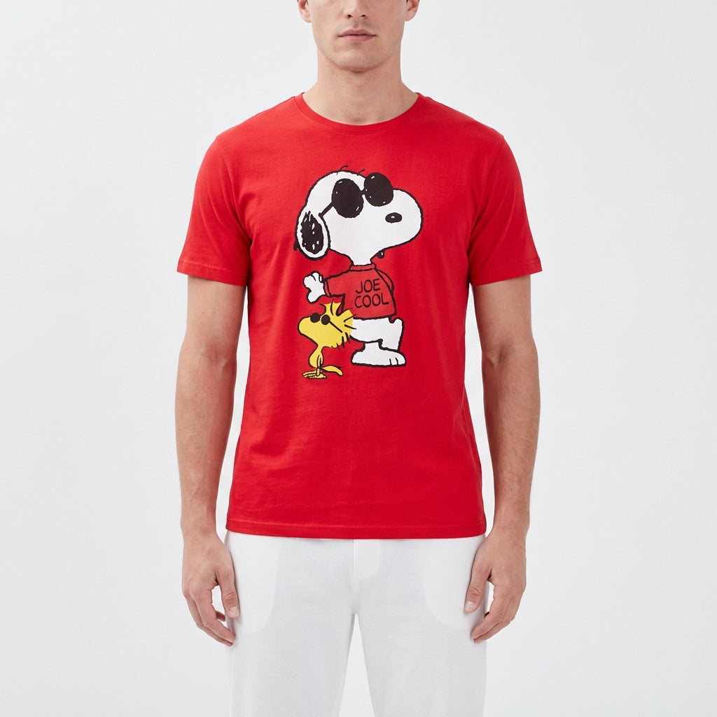 Close-up of Snoopy Joe Cool sleep shirt for men, showcased on a model with white lounge pants in a bright studio setting, highlighting modern fashion style.