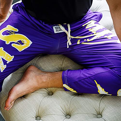 Birds eye view image of model sitting and wearing SKOL pajama lounge pants