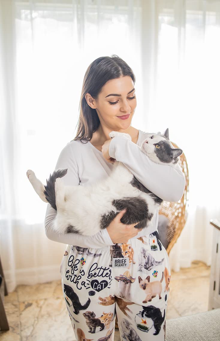 Image of female model cradling a cat and wearing Life Is Better With A Cat pajama lounge pants