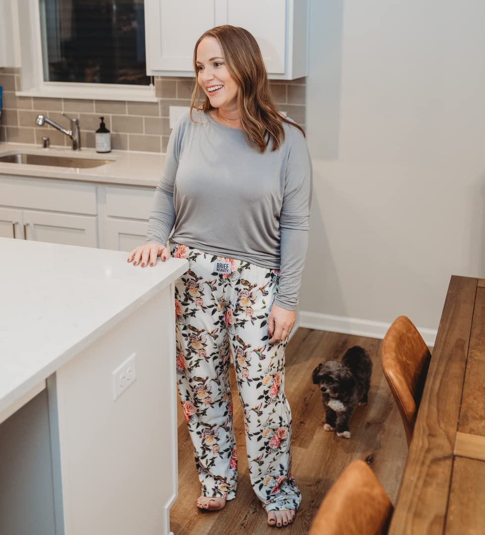 Image of female mode standing in a kitchen by the counter wearing Hummingbird Pattern pajama lounge pants