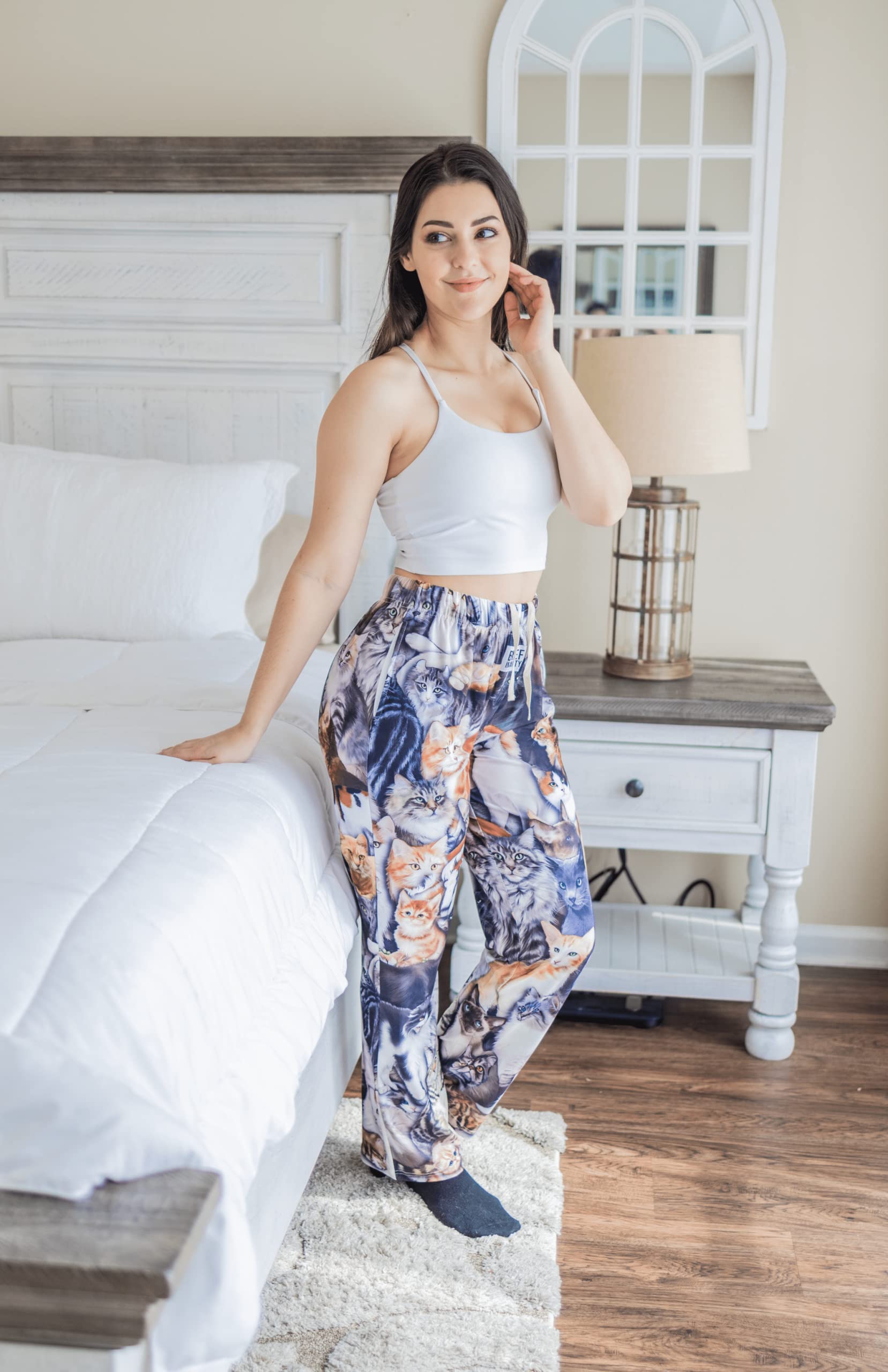 Image of female model posing by side of bed wearing All Over Cat pajama lounge pants