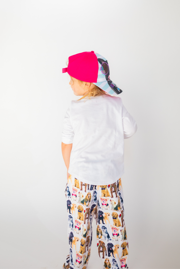 Image of little girl model standing and wearing Ruff Day kids cap backwards (back view white background)