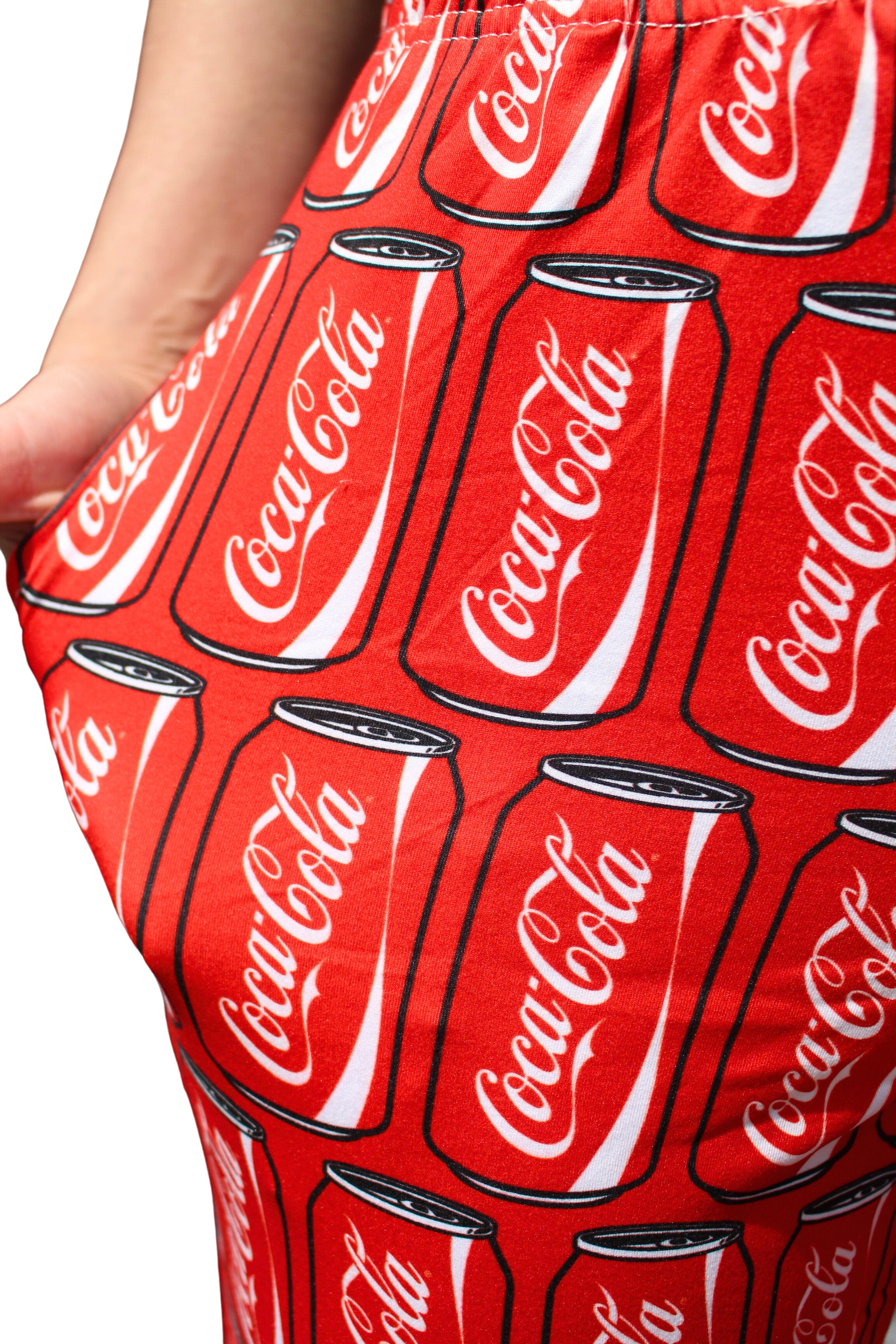 Coca-Cola Can Pattern Pajama Lounge Pants on model close up view of coca cola can pattern by right pocket