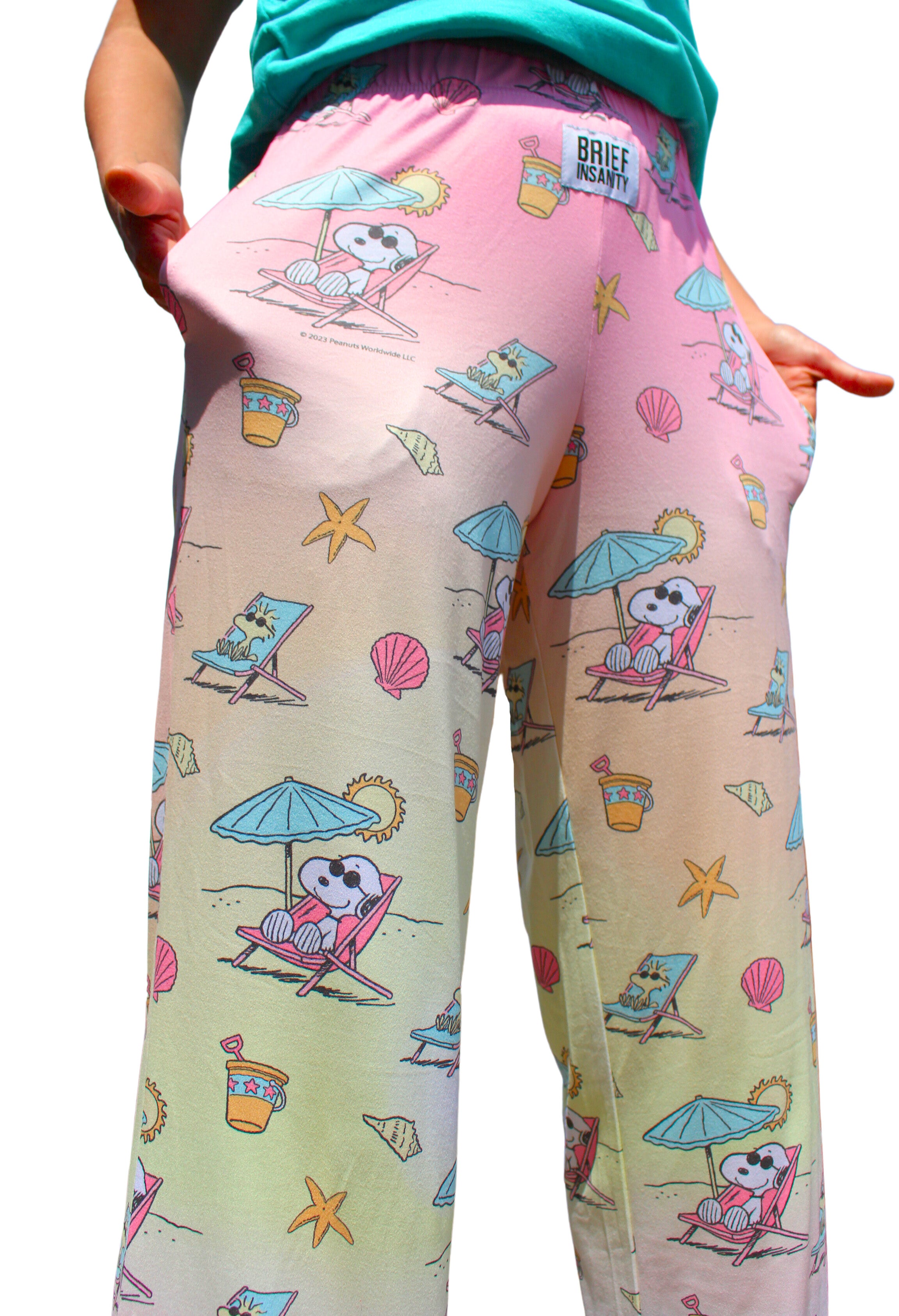 Person showing pockets on BRIEF INSANITY Snoopy Beach Pajama Lounge Pants