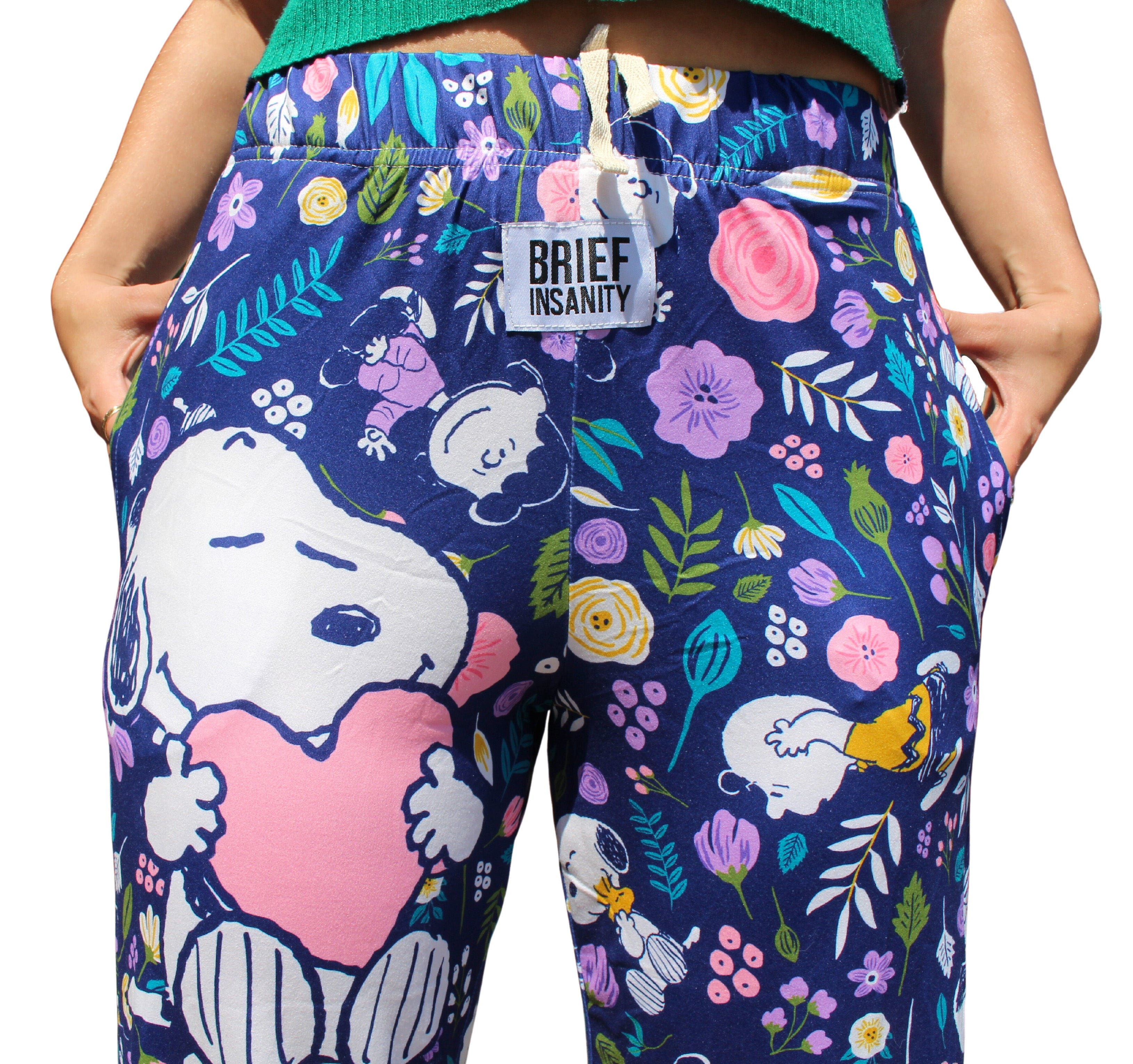 Snoopy Floral Love pajama lounge pants on model close up front view of Snoopy graphic