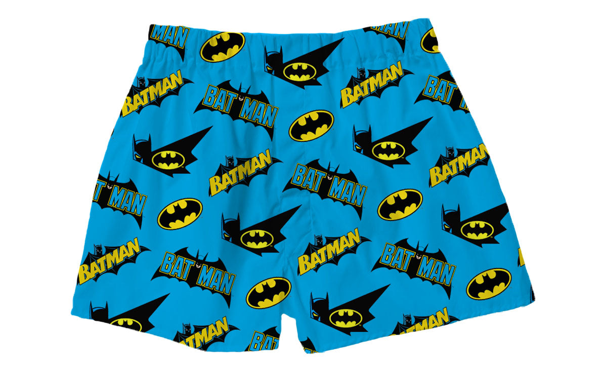 Batman Logos Blue Boxer Shorts featuring vibrant yellow Batman logos and bold 'BATMAN' text in black and blue on a bright blue background – Warner Bros. Discovery.