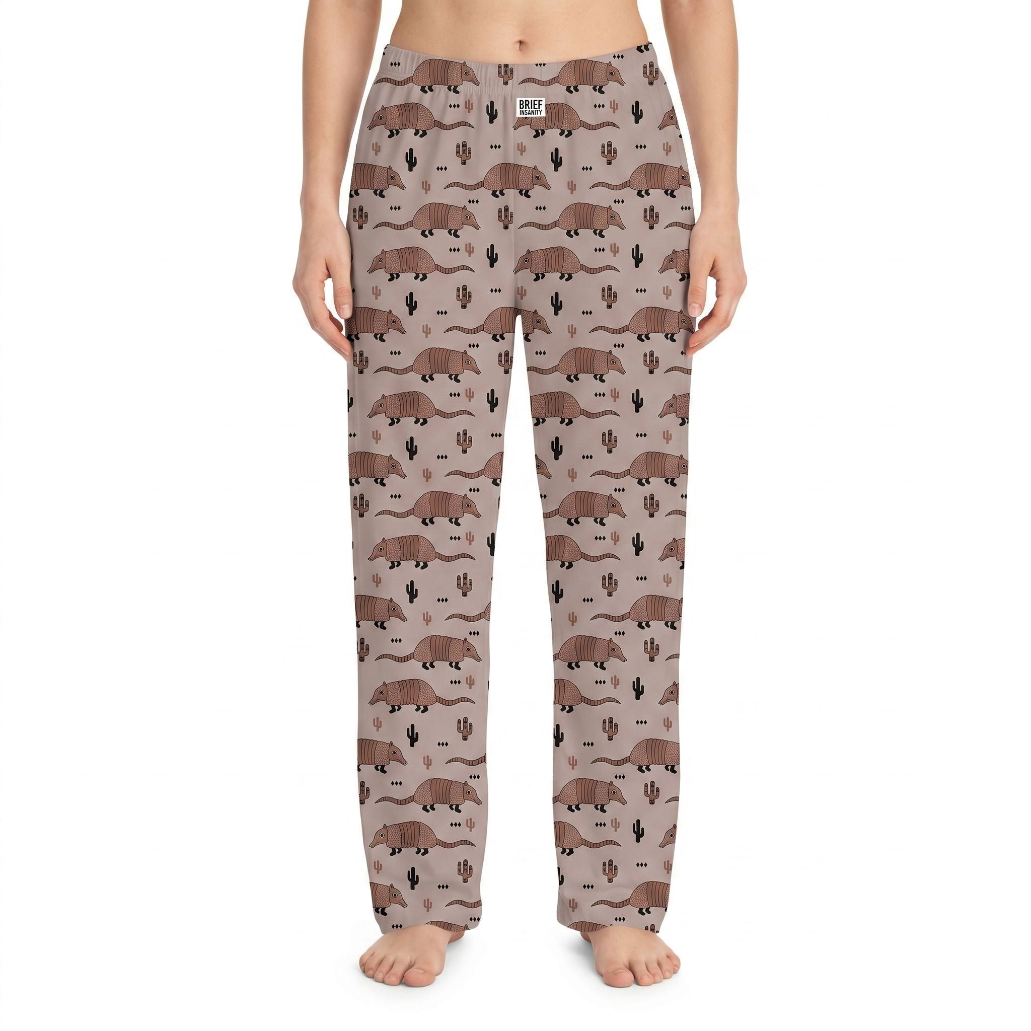 Studio shot of Armadillo Lounge Pants with allover armadillo and cactus print on a model against a white background, showcasing fabric details and vibrant colors.