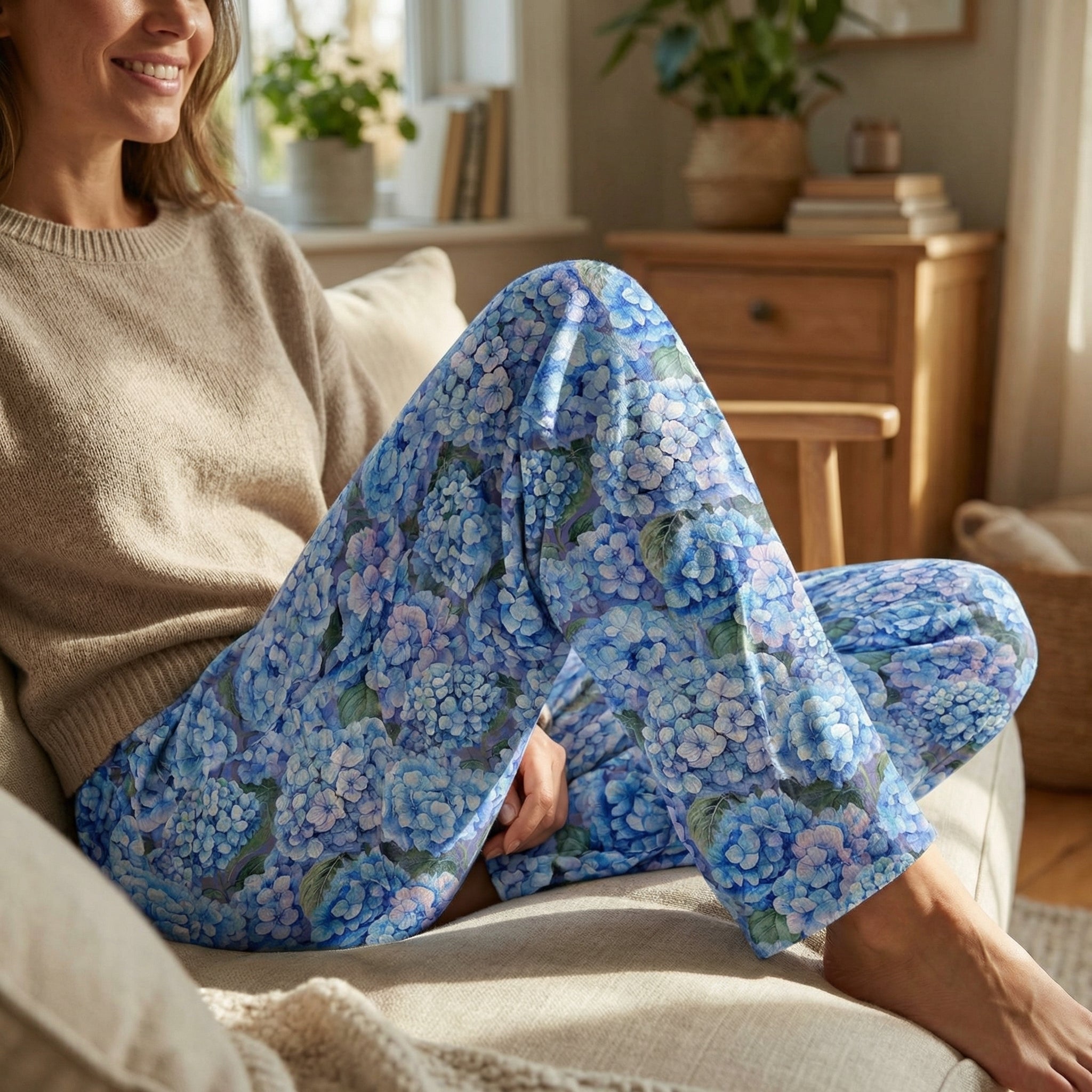 Close-up of Blue Hydrangea Lounge Pants showing intricate floral pattern in shades of blue and lavender, highlighting fabric texture and color vibrancy on a model.