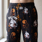 Close-up of Boofoot Orange Halloween Lounge Pants showcasing pumpkin and ghost pattern on a mannequin