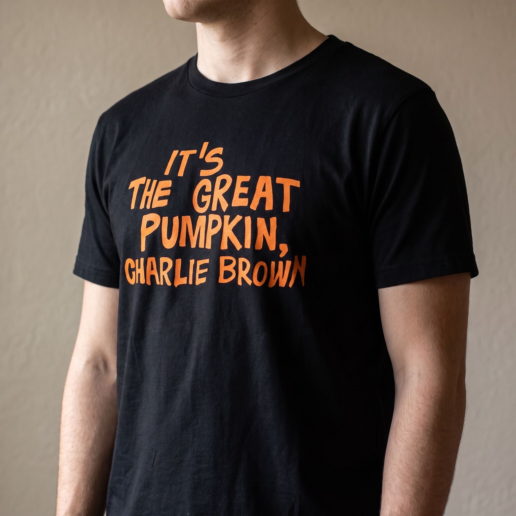 Close-up of Charlie Brown Great Pumpkin T-Shirt on a model, showing vibrant print and soft cotton fabric.