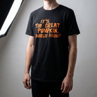Full-body view of Charlie Brown Great Pumpkin T-Shirt on a model in a minimalist studio, highlighting relaxed fit and print.