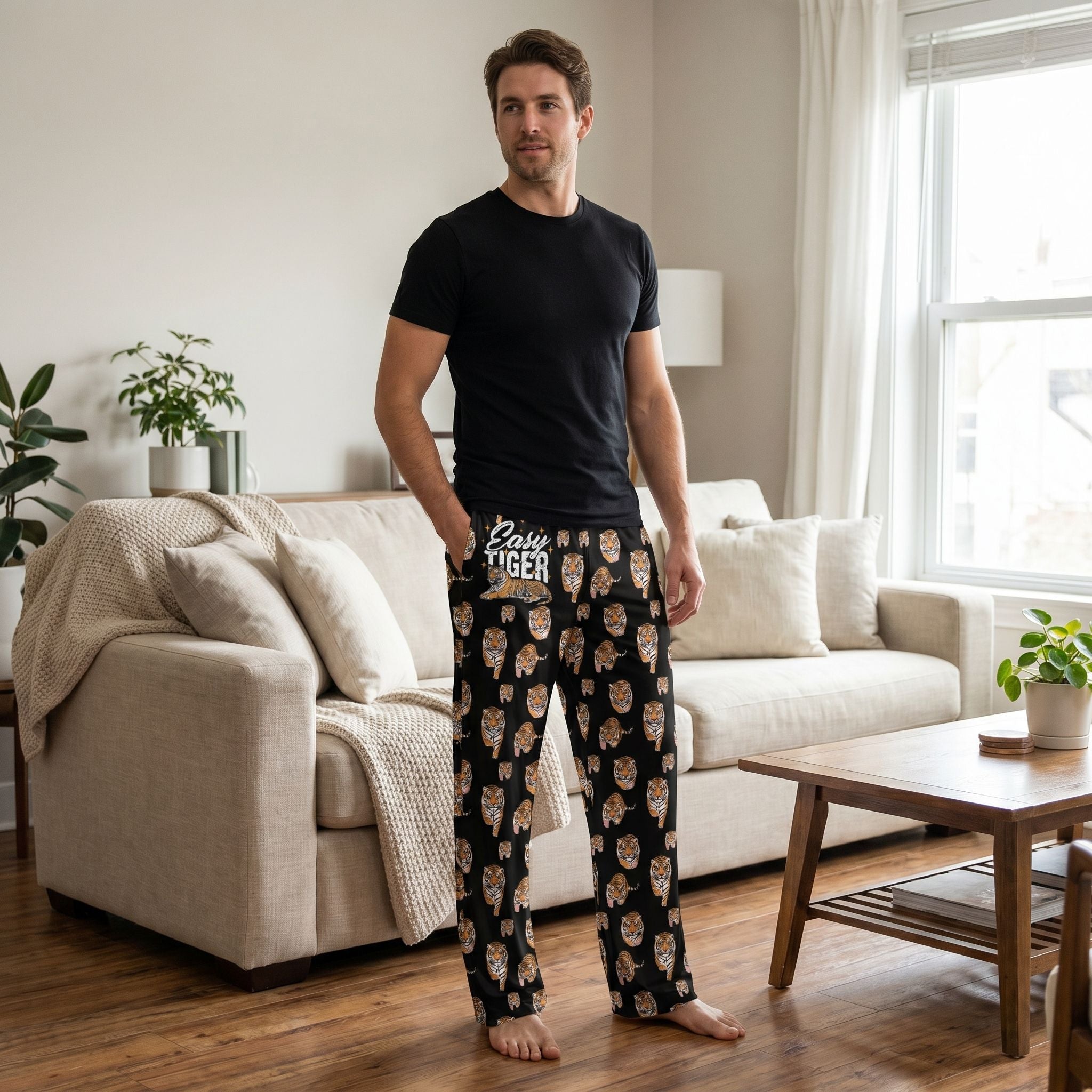Male model wearing Easy Tiger Lounge Pants in a cozy home setting, showcasing the tiger print and relaxed style.