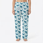 Model wearing Everything Whale Be Alright lounge pants with whale and seaweed print on a white background, centered and fully visible.