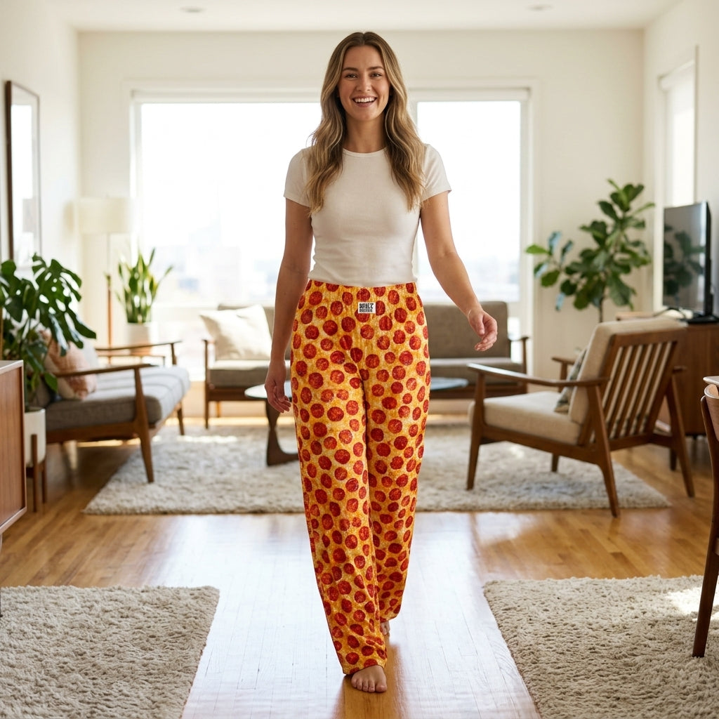 Cheerful model wearing Pepperoni Lounge Pants in bright home, highlighting loose fit, wide leg design, and vibrant playful print.