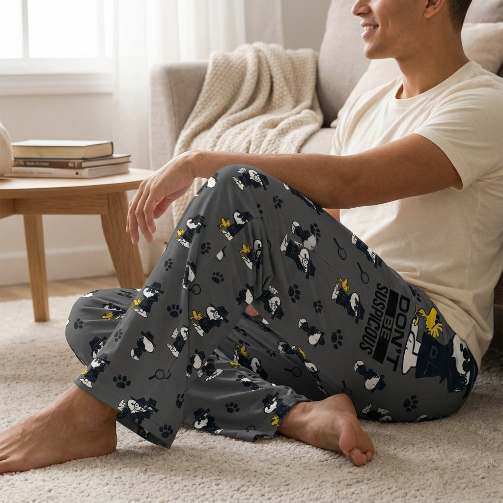 Relaxed model wearing Detective Snoopy Lounge Pants in a cozy living room, highlighting the loose fit and lightweight fabric details.