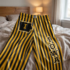 Close-up of Iowa Pride striped pajama lounge pants showing Iowa lettering and soft fabric texture.