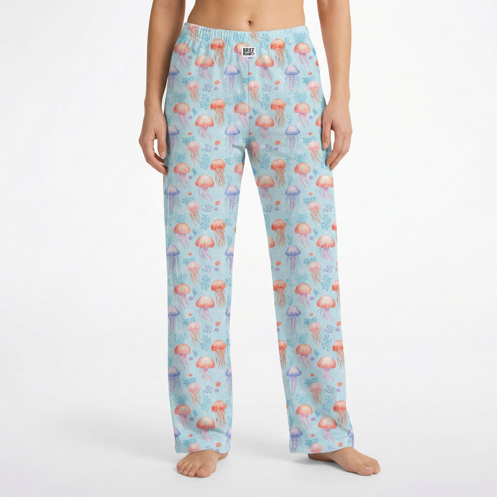 Model wearing Jellyfish Lounge Pants with ocean-inspired pattern, cropped from waist to ankles on white background.