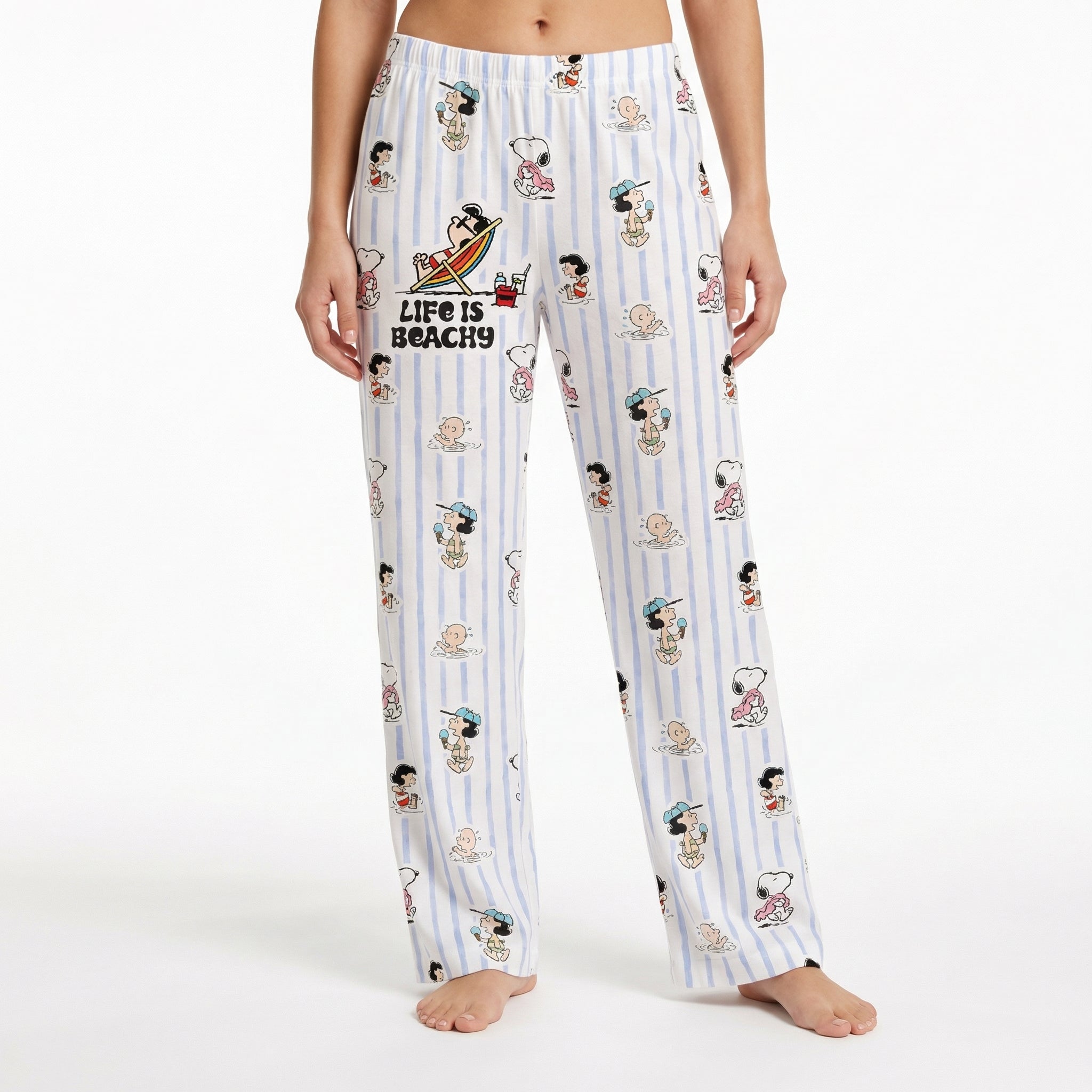 Relaxed Snoopy lounge pants with beach-inspired design on model against white background.