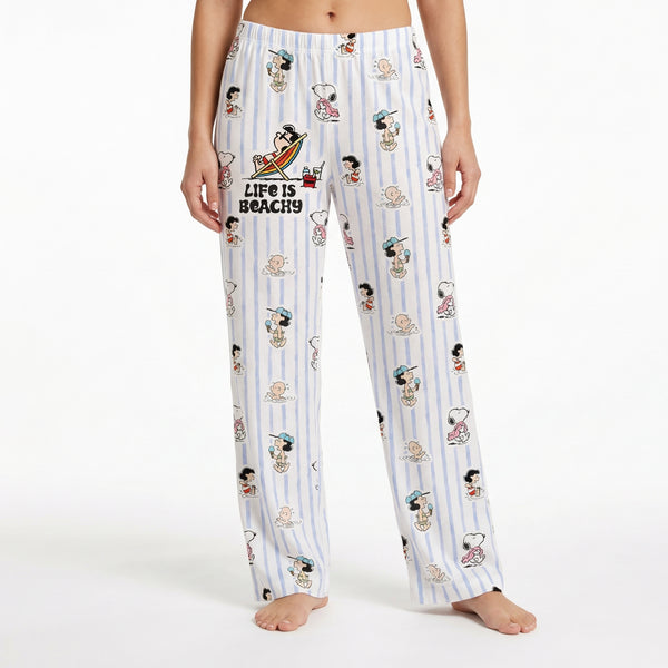 Relaxed Snoopy lounge pants with beach-inspired design on model against white background.