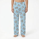 Model wearing Bugs Bunny lounge pants with Looney Tunes print on white background, cropped from waist to ankles.
