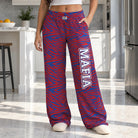Person wearing Mafia zebra print lounge pants with blue and red stripes standing in a modern kitchen with side pockets visible.