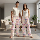 Full-body shot of models wearing Nurse Doodles Lounge Pants in a cozy living room, highlighting relaxed fit and colorful pattern.