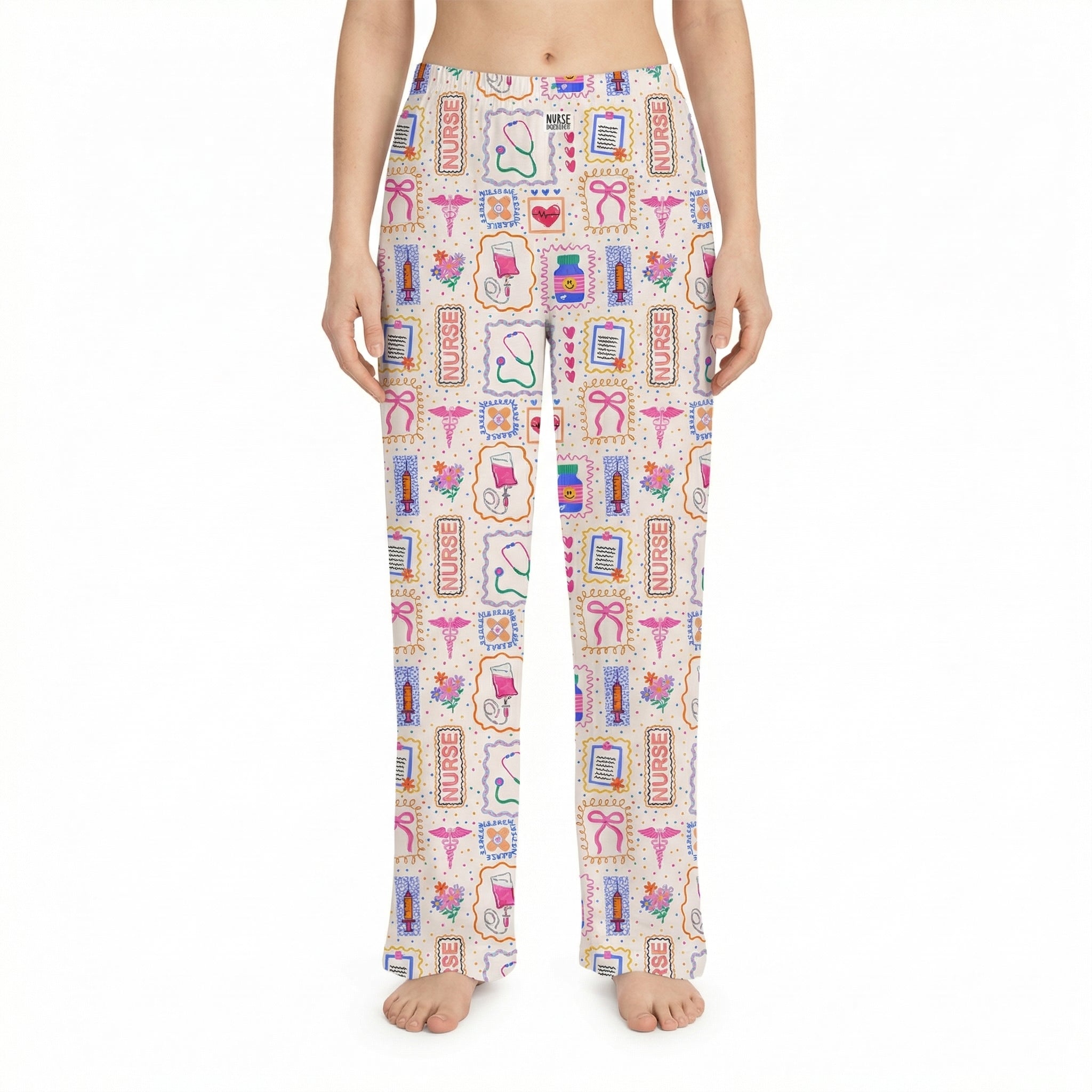 Model wearing Nurse Doodles lounge pants with medical icons on a white background, showcasing vibrant colors and relaxed fit.