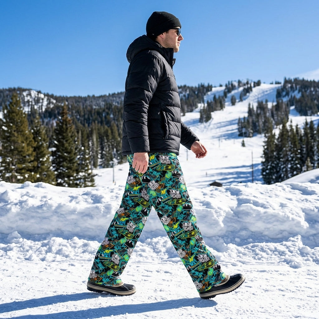 Model walking outside on snow wearing snowboard lounge pants with vibrant accents, emphasizing fabric movement and practical fit in a snowy landscape.