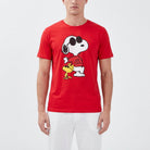 Close-up of Snoopy Joe Cool sleep shirt for men, showcased on a model with white lounge pants in a bright studio setting, highlighting modern fashion style.