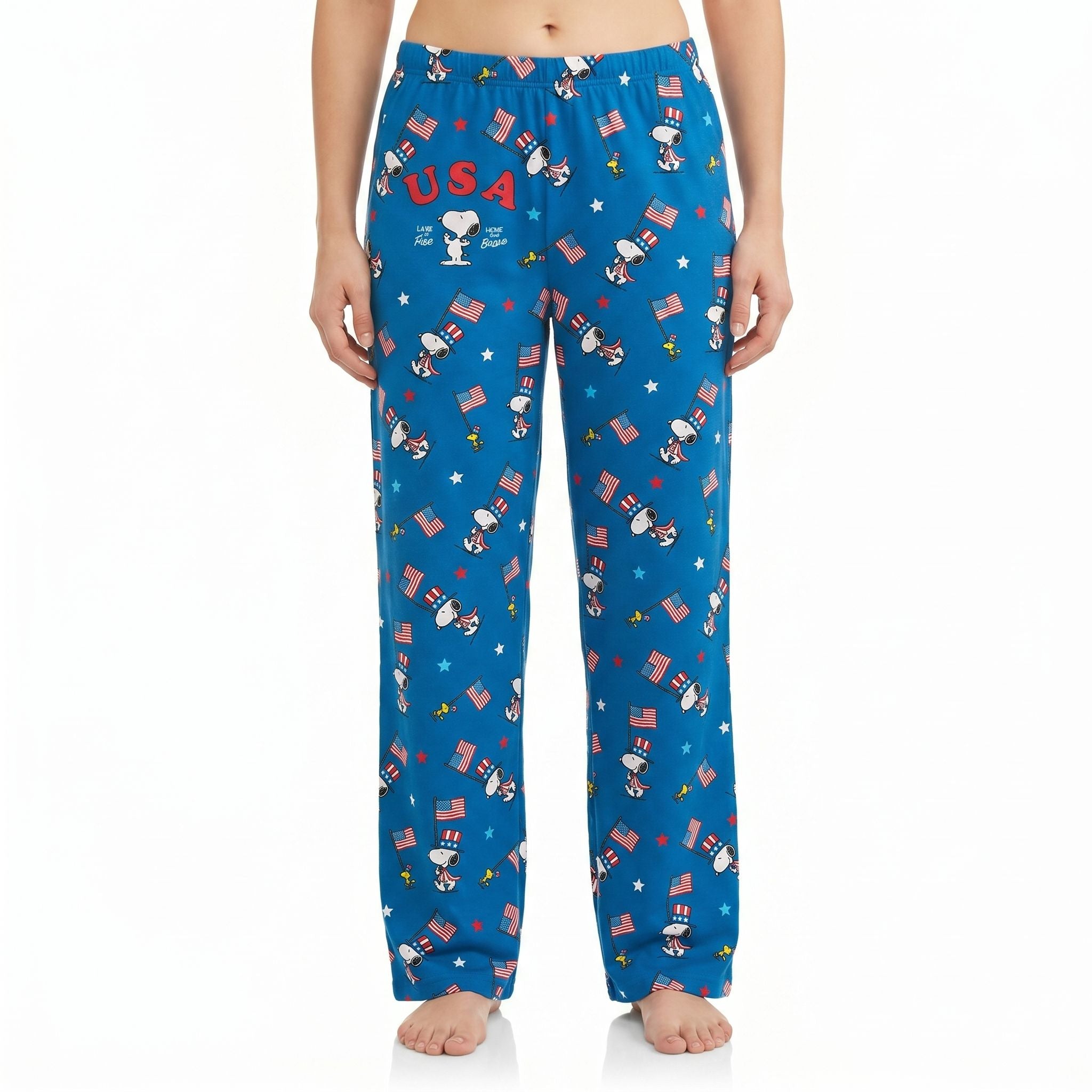 Model in patriotic Peanuts USA Flag March Lounge Pants with Snoopy on white background, showcasing vivid print and relaxed fit.