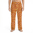 Model wearing vibrant pepperoni pizza lounge pants with all-over print, cropped from waist to ankles, against a white background.