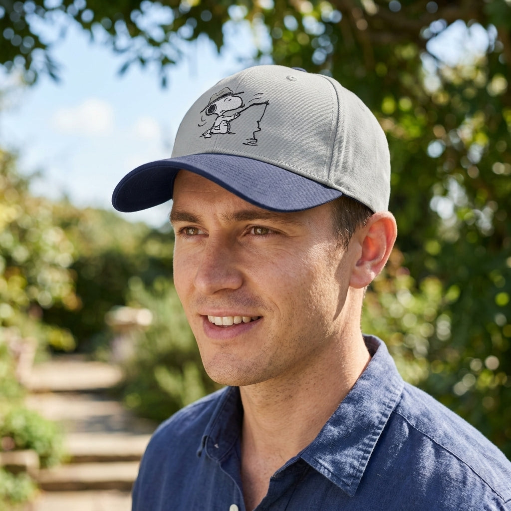Person wearing Snoopy Fishing Embroidered Cap outdoors in garden, highlighting fit, comfort, and embroidery detail in natural sunlight.