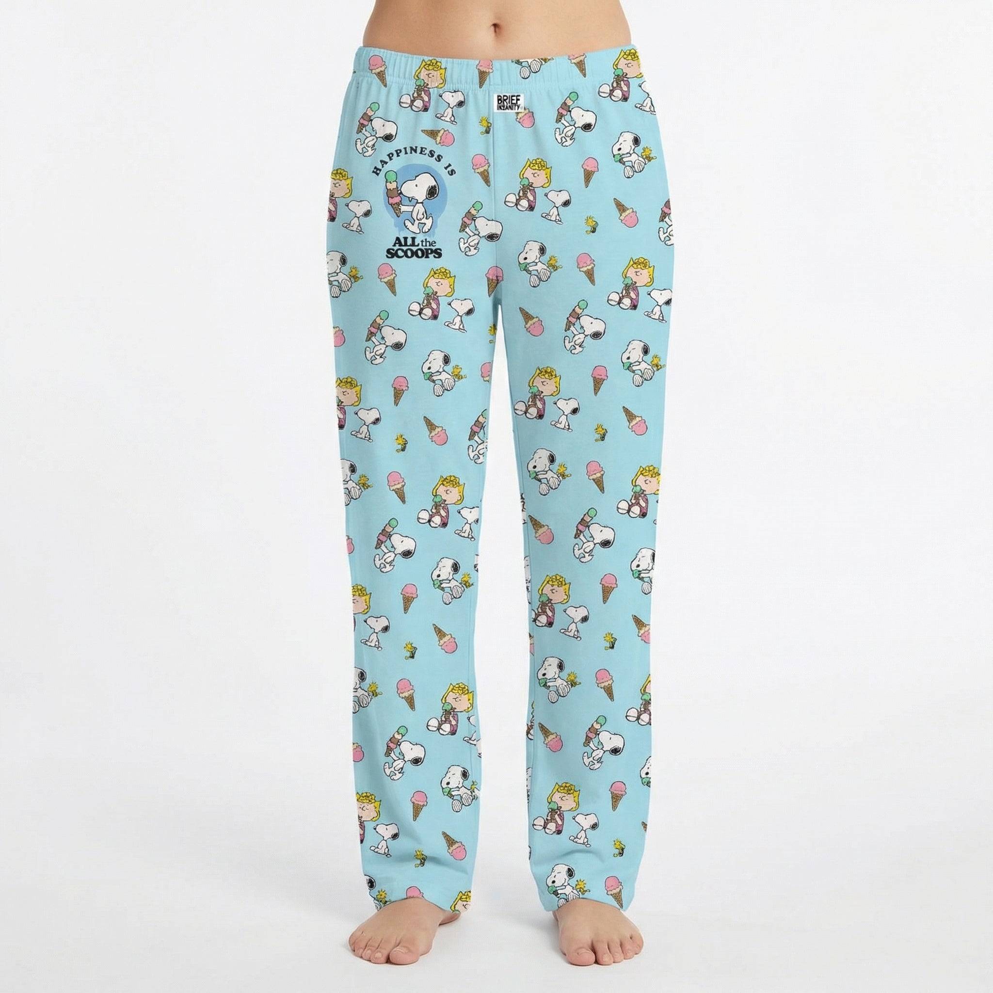 Model wearing Snoopy Ice Cream Lounge Pants with all-over print of Snoopy and friends enjoying ice cream treats, on a white background.