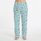 Model wearing Snoopy Ice Cream Lounge Pants with all-over print of Snoopy and friends enjoying ice cream treats, on a white background.