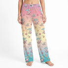Studio product shot of Snoopy beach lounge pants on a model, centered on white background, showing detailed print and natural fabric drape.