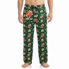 Model wearing green football-themed lounge pants featuring Snoopy and game day graphics, cropped from waist to ankles against white background.