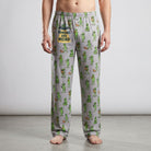 Full-length studio shot of a person modeling lightweight polyester alien-print lounge pants.