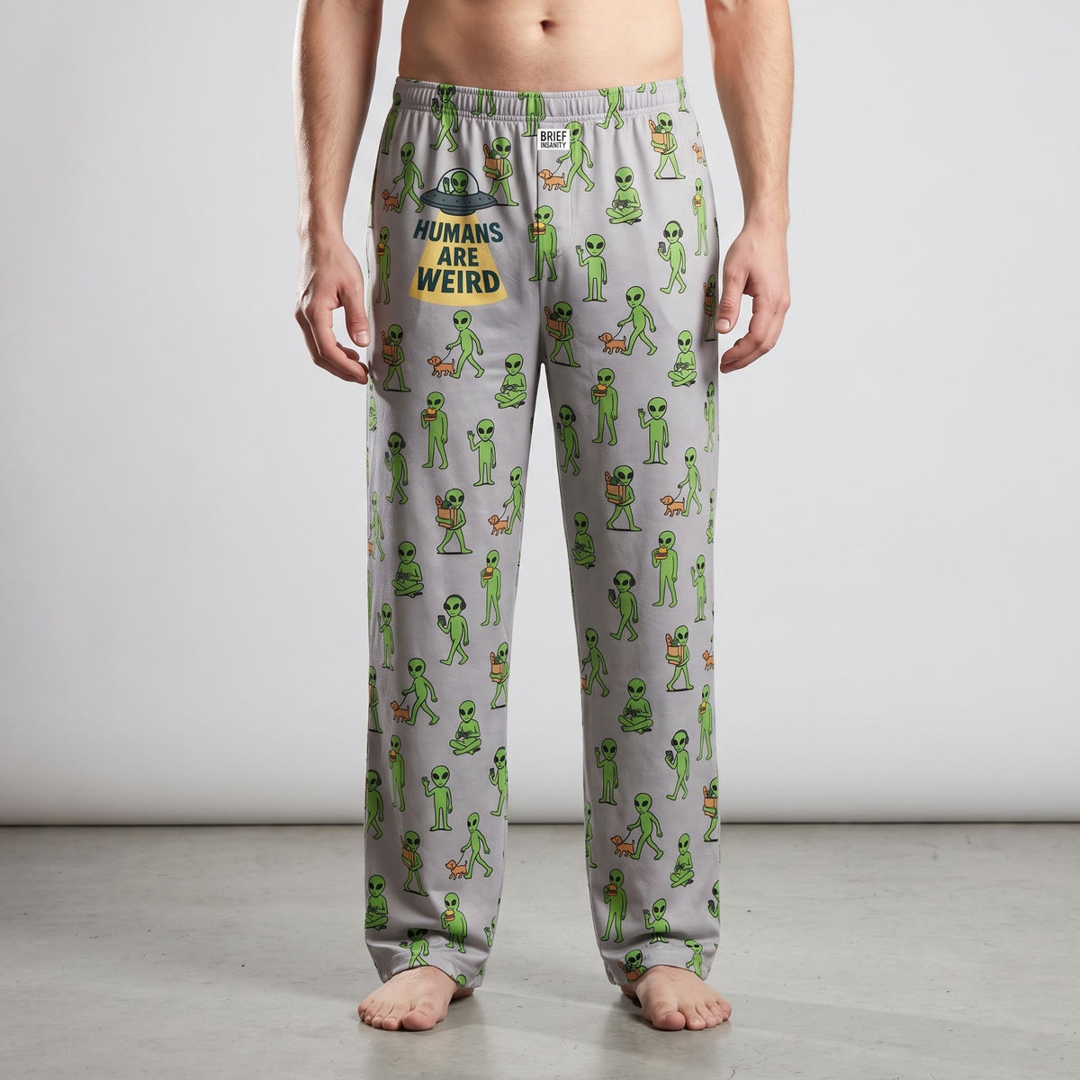 Full-length studio shot of a person modeling lightweight polyester alien-print lounge pants.