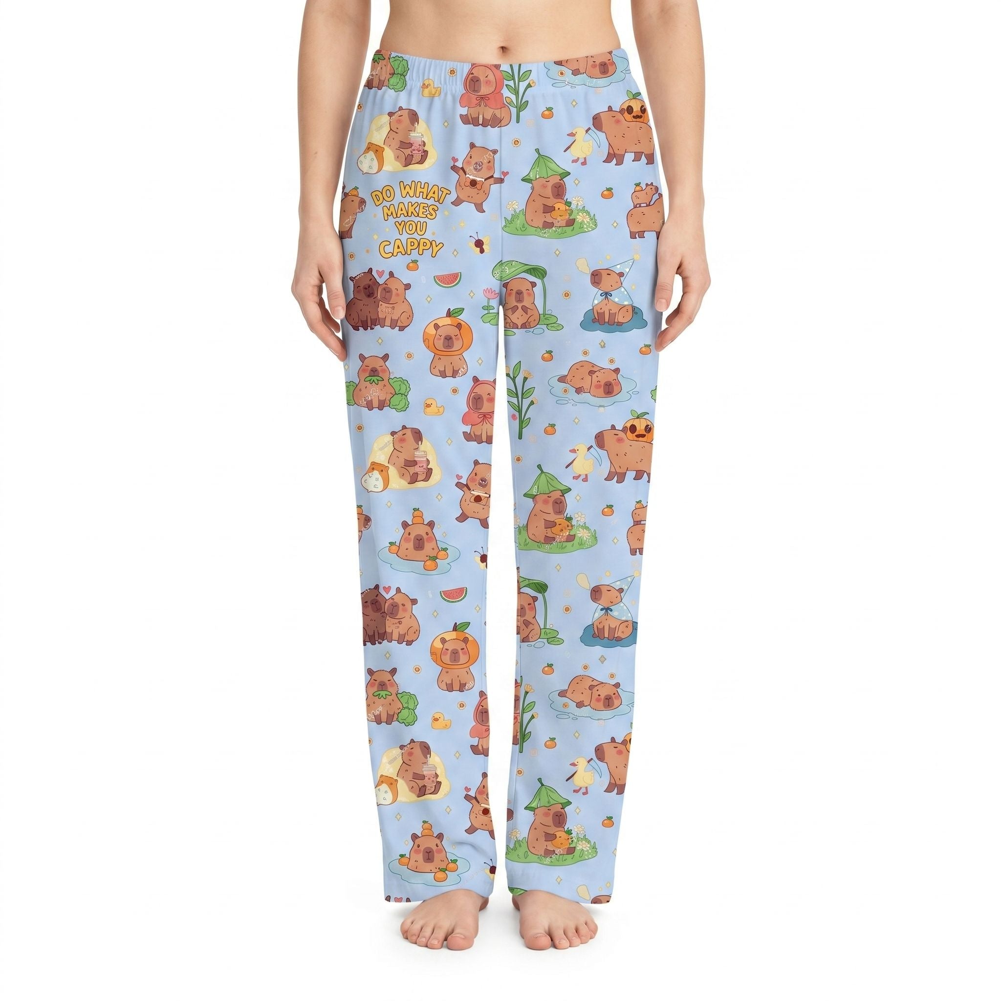 Model wearing vibrant capybara lounge pants with all-over print of lounging capybaras, centered on white background, natural fabric drape.