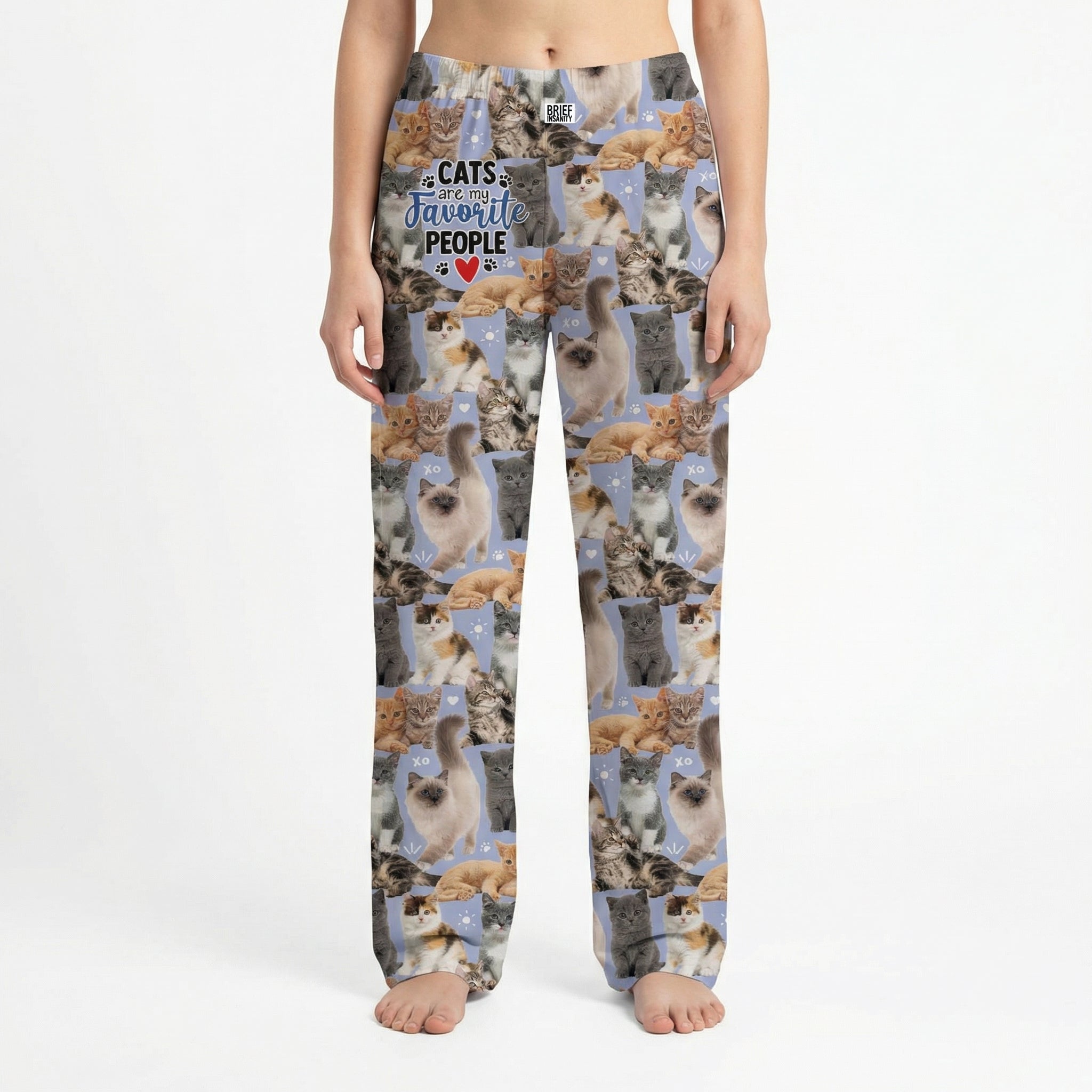Model standing in lively living room wearing Cats Favorite People Lounge Pants, vibrant print clearly visible, natural light highlighting colors.