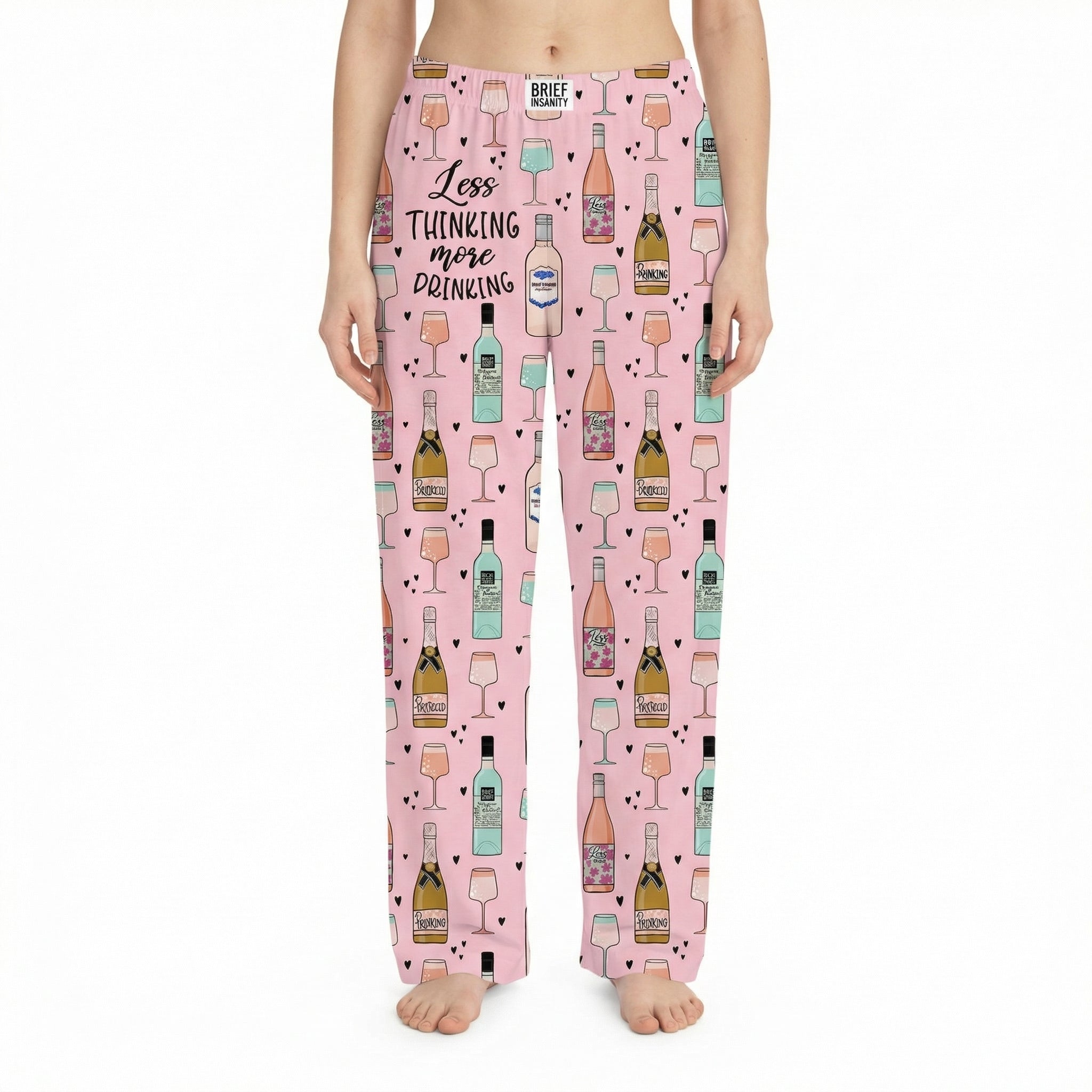 Relaxed lifestyle image of woman in pink lounge pants lounging on sofa, softly lit cozy interior emphasizing comfort and fabric.
