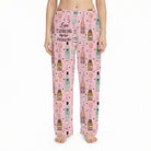 Relaxed lifestyle image of woman in pink lounge pants lounging on sofa, softly lit cozy interior emphasizing comfort and fabric.