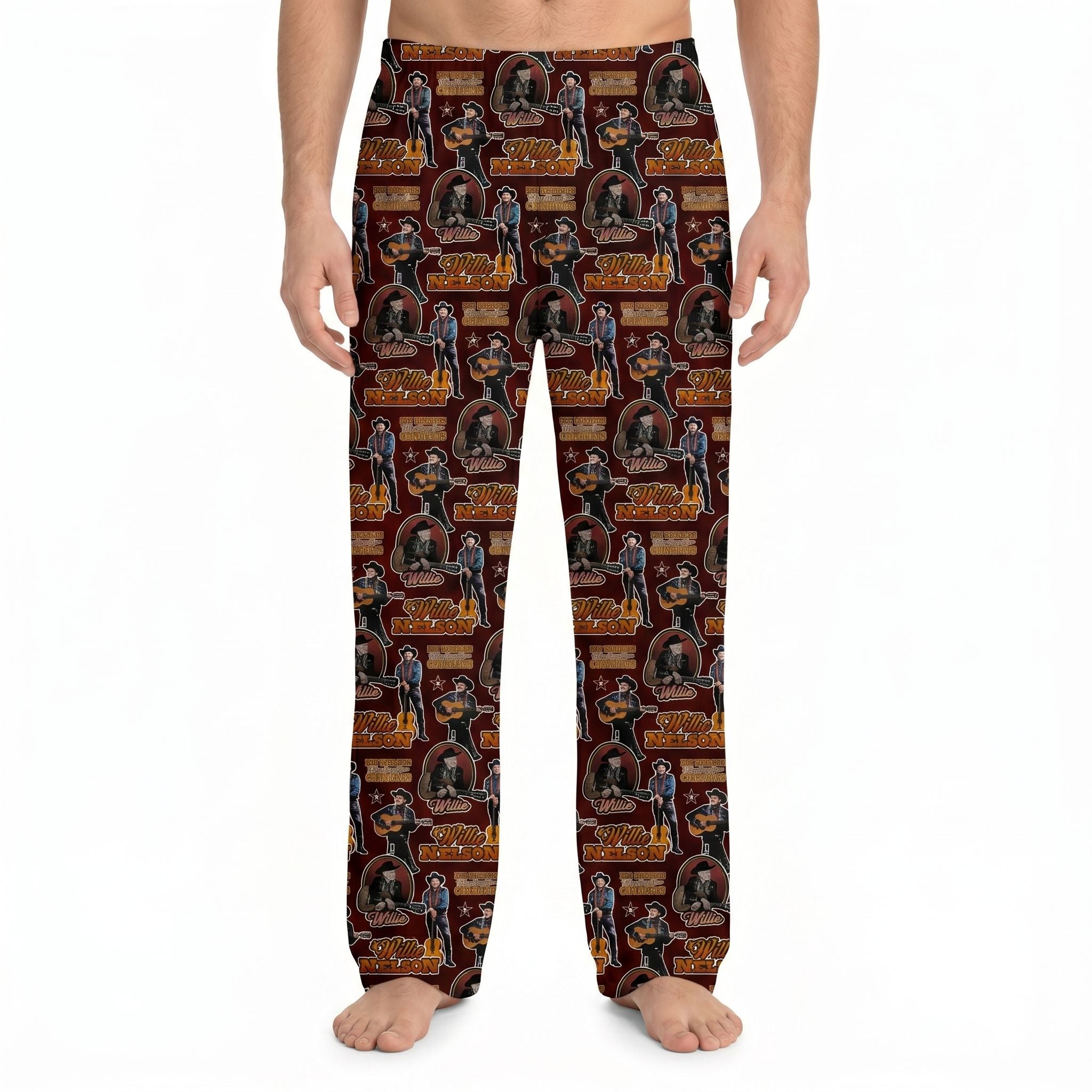Model wearing Willie Nelson all-over pattern lounge pants with guitar and cowboy hat print on deep red fabric, against white background.
