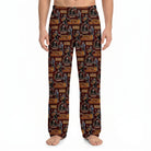 Model wearing Willie Nelson all-over pattern lounge pants with guitar and cowboy hat print on deep red fabric, against white background.