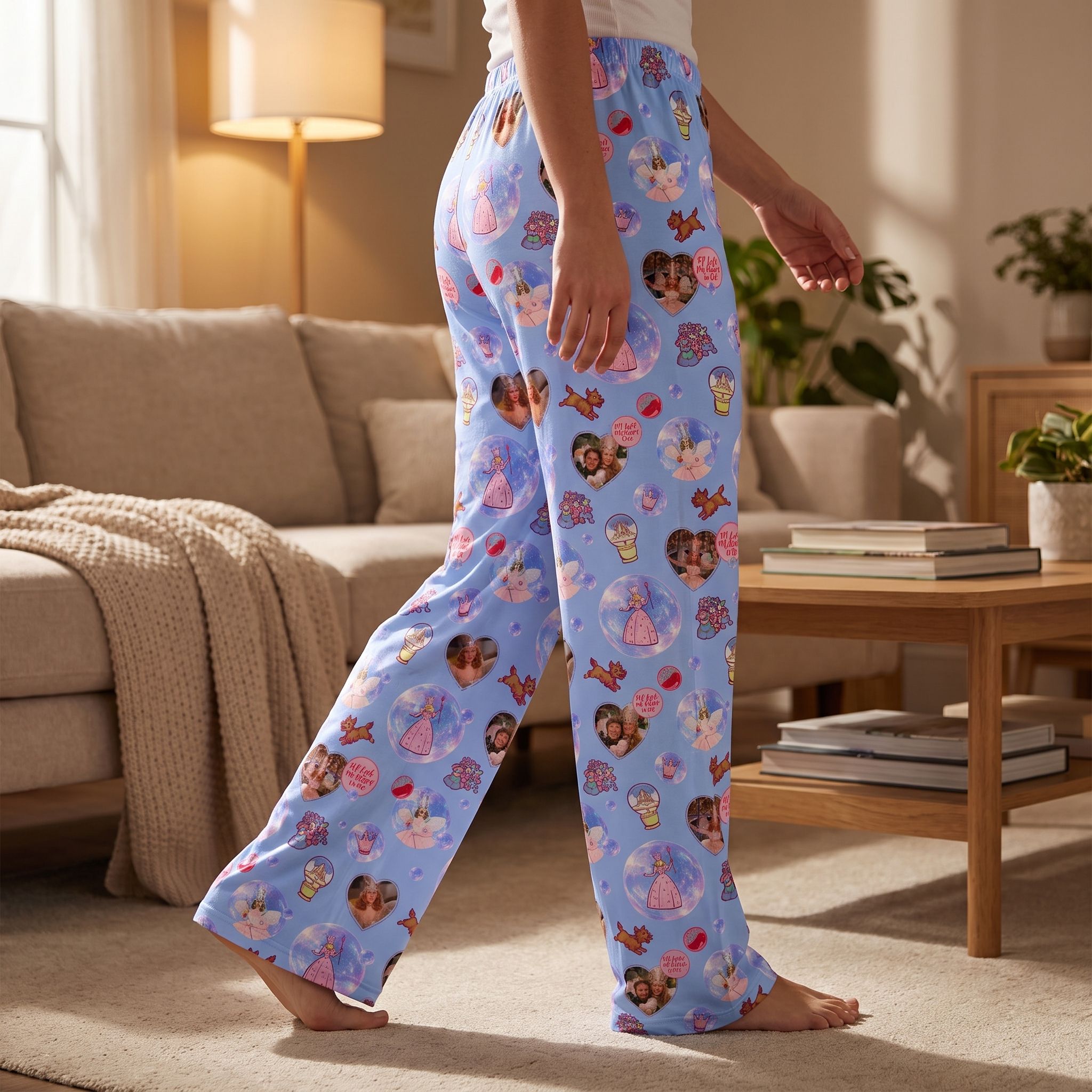 Side view of person walking in Wizard of Oz Glinda lounge pants highlighting colorful pattern, relaxed fit, and airy fabric in a warm living room.