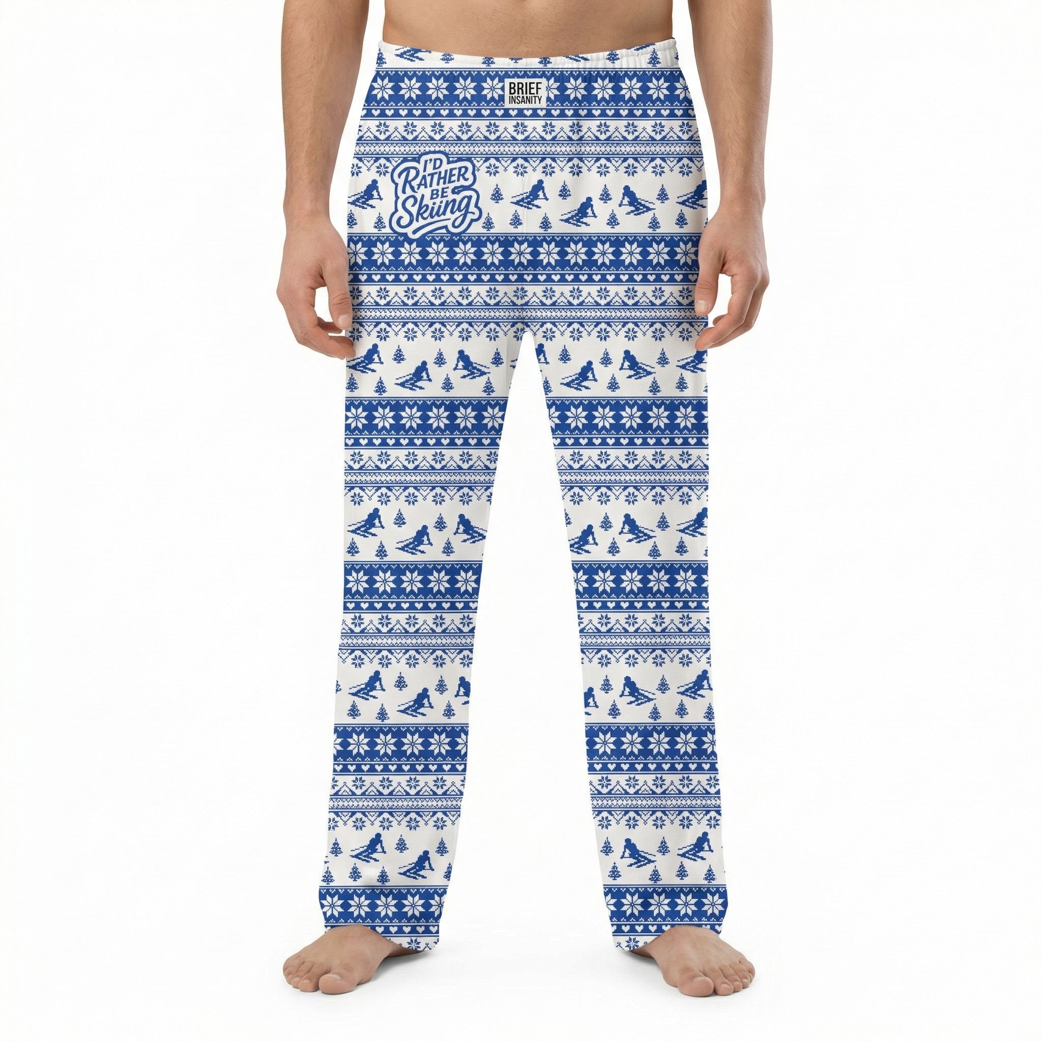 Model wearing I'd Rather Be Skiing lounge pants with snowflakes and pine trees pattern on white background.